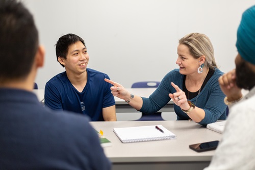 Professor Rhianna helping students