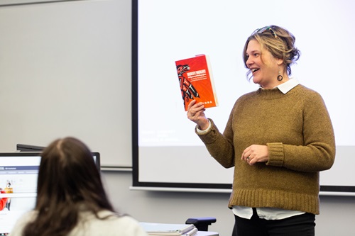 Prof holding a book