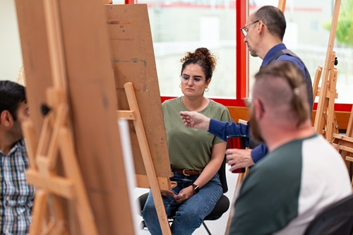 Fine Arts prof helping a student