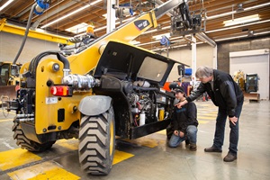 Student and professor examining telehandler