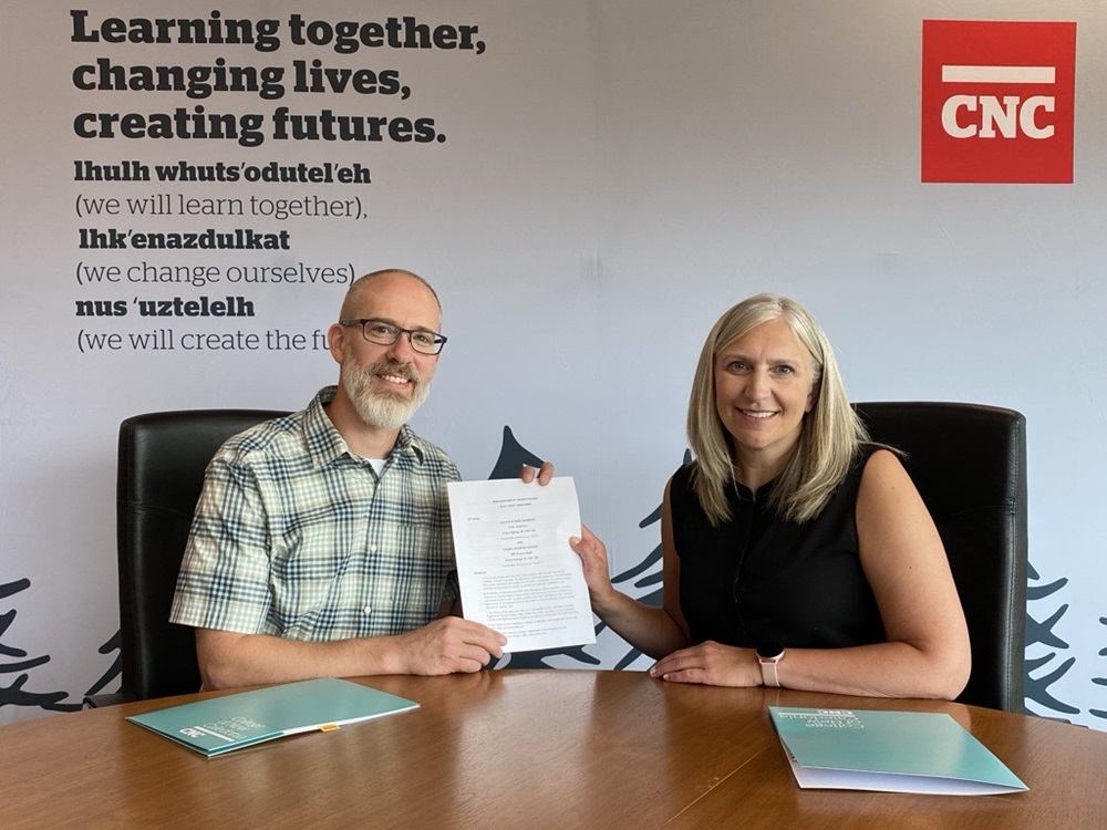 Cedars Principal Shane Nelson (left) and CNC President Cindy Heitman (right) hold the signed dual credit agreement that will support high school students transitioning to post-secondary education.