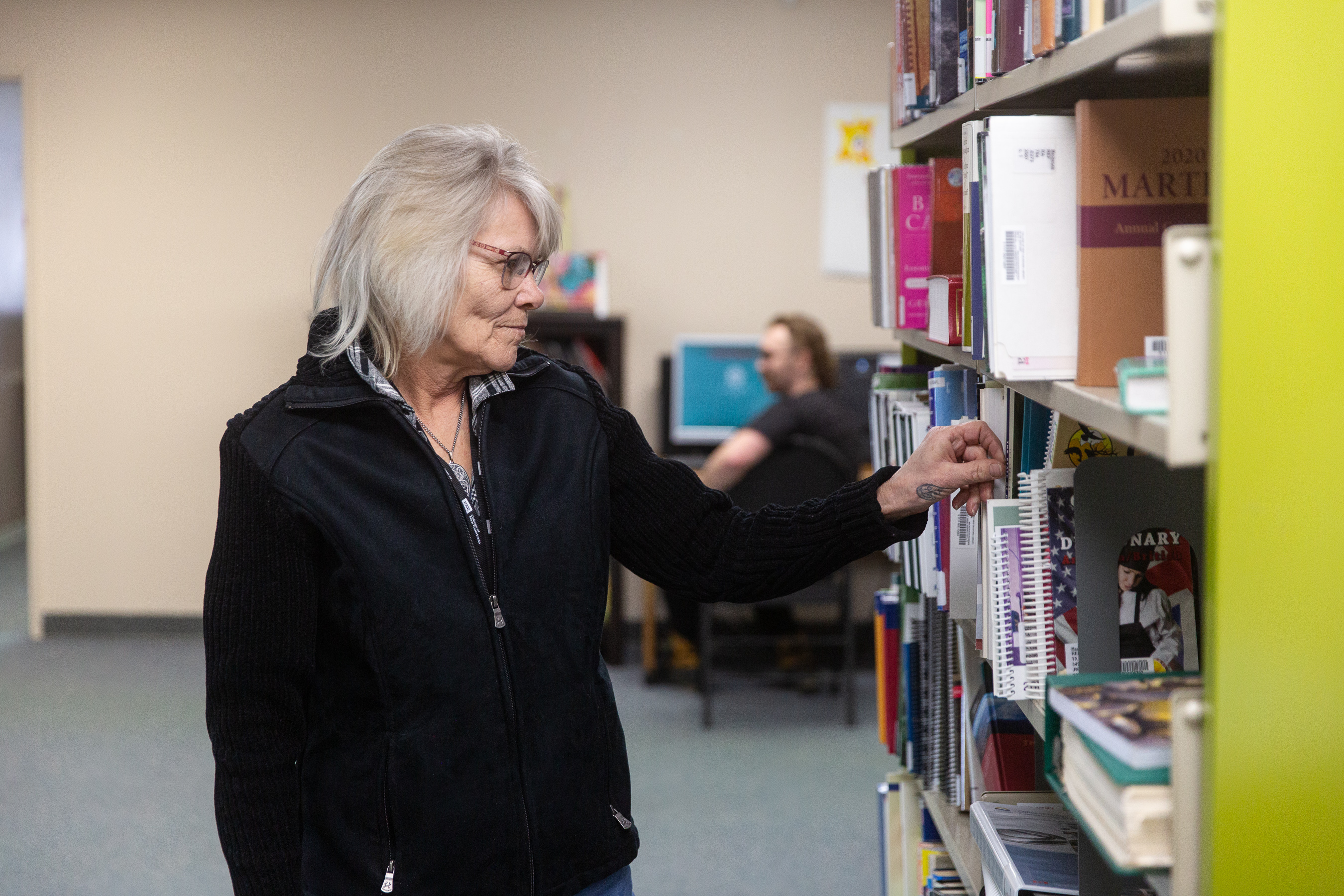 Woman selecting a book in a library