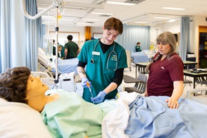 Nursing student practicing on dummy