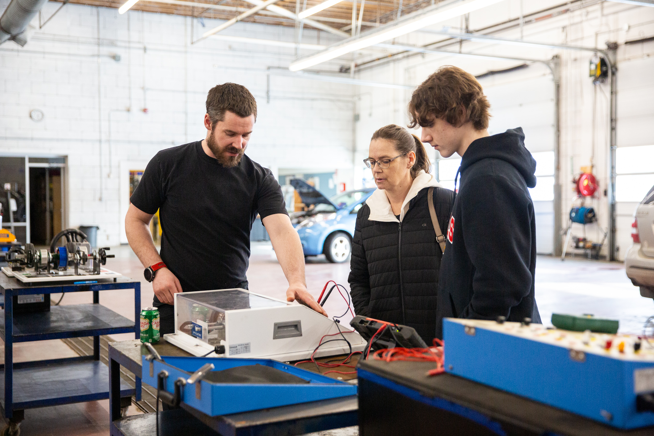 Future student getting a tour of auto shop
