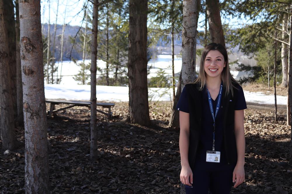 Casey wearing her nursing lanyard and scrubs