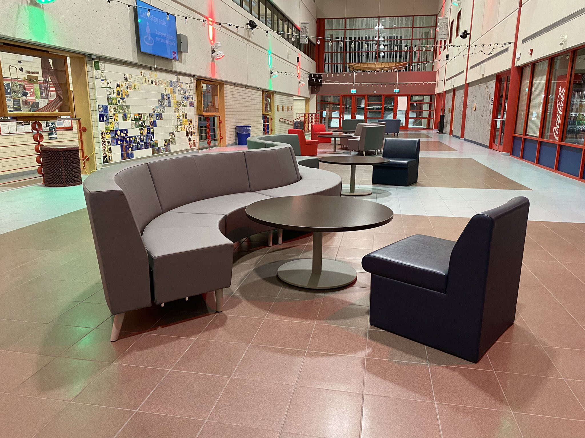 A curved couch and large arm chairs in the Gathering Place