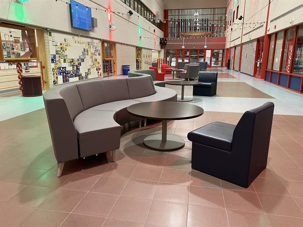 A curved couch and large arm chairs in the Gathering Place