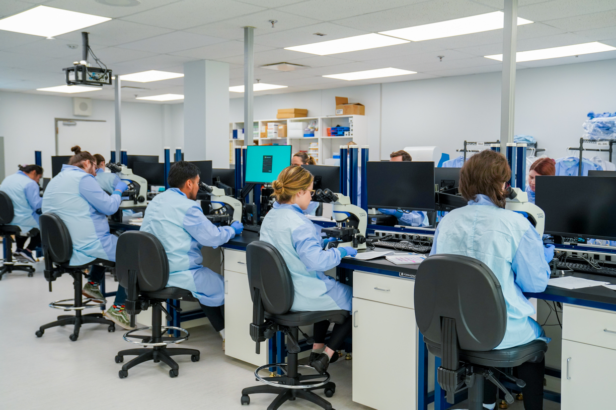 Students at their desks using microscopes in new dry lab