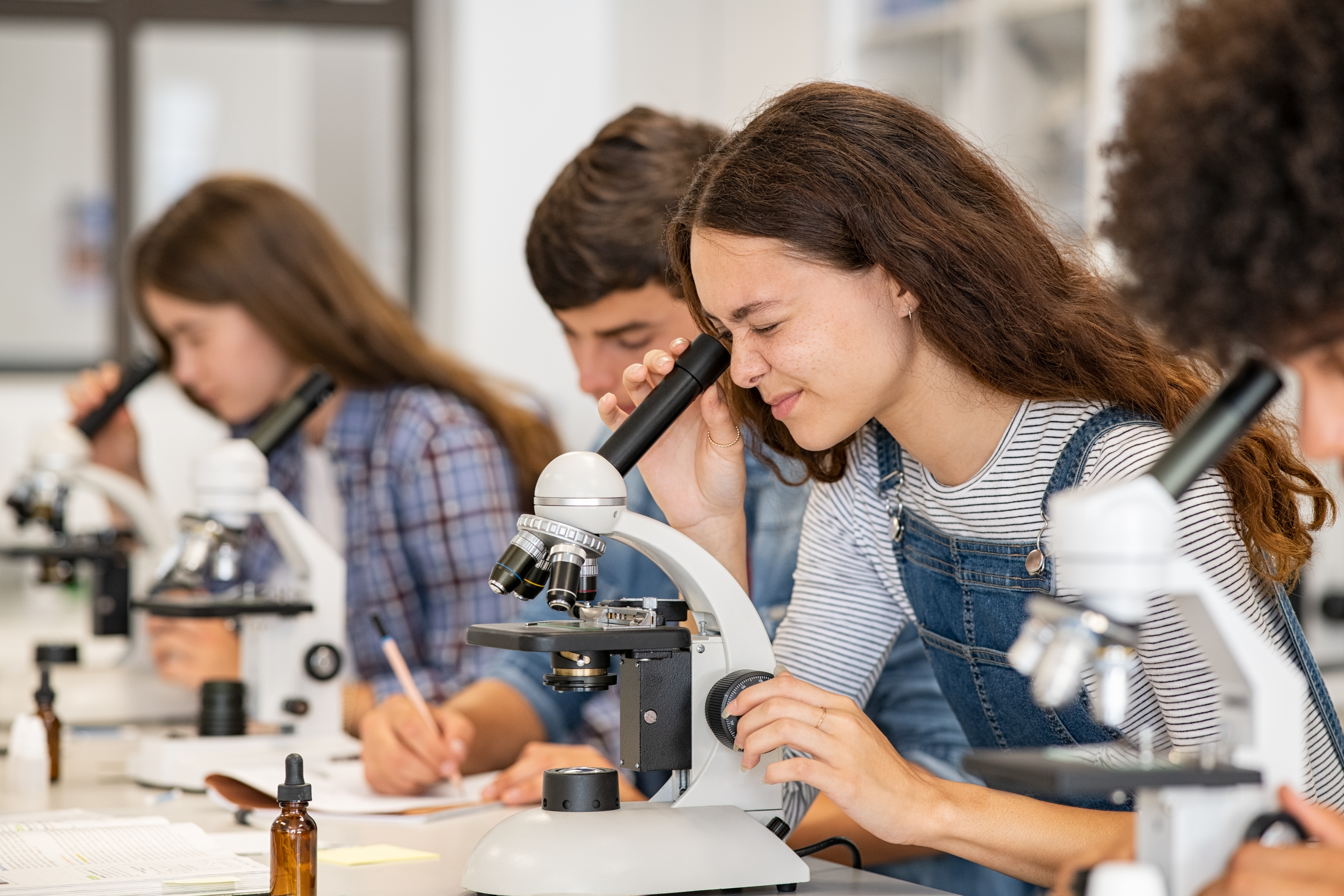 Stock Image - Teens learning biology