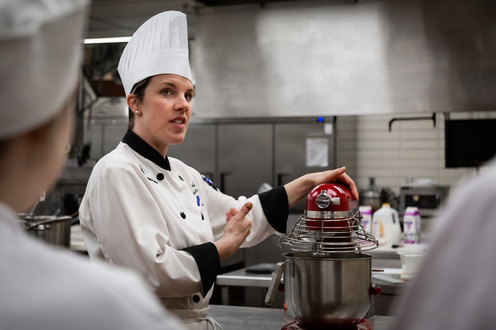 Chef Mandy teaching students with a stand mixer