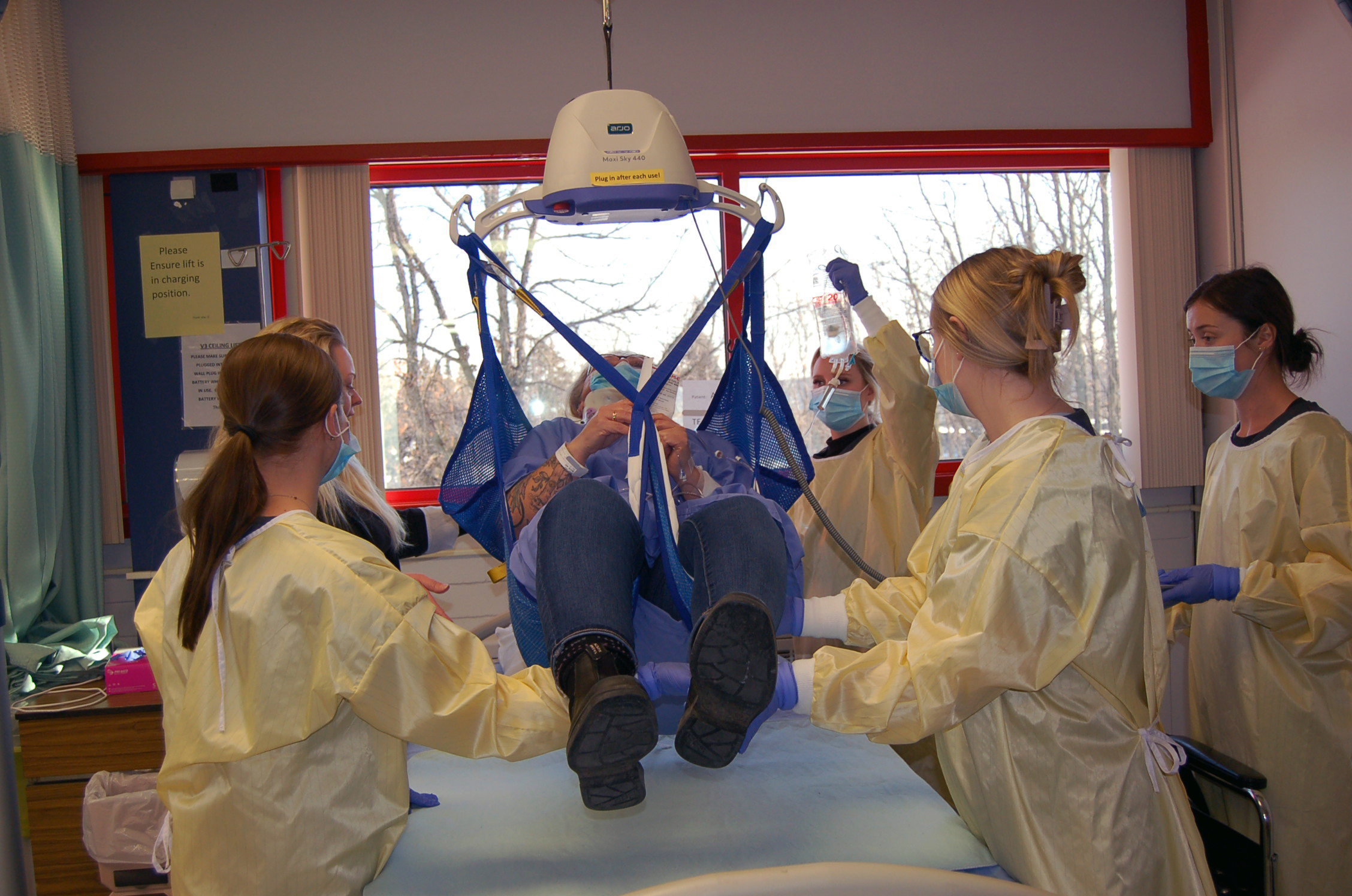 Sonography Students using lift to move a patient