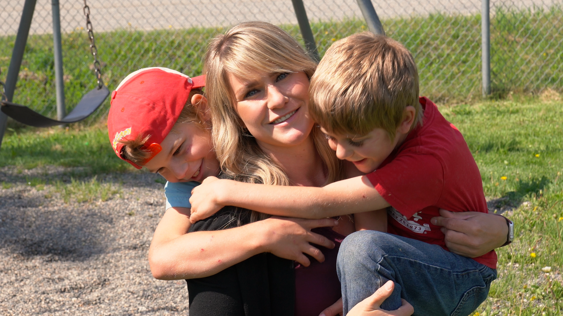 Tamara is being hugged by her two children